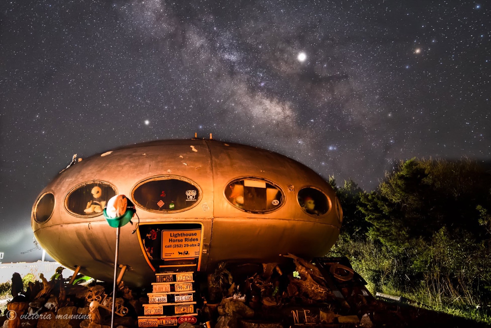 Futuro-style flying-saucer house lit under starry night sky